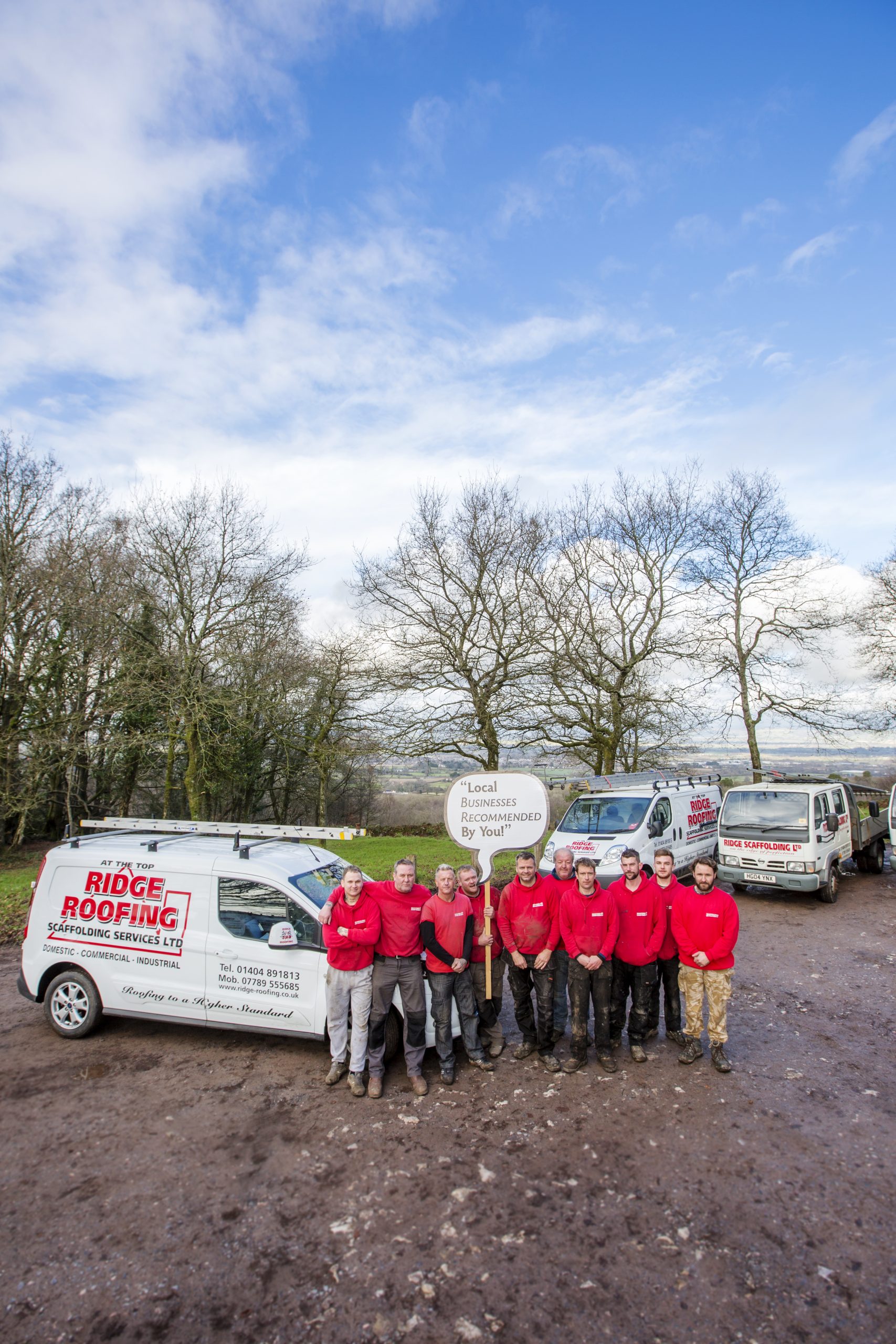 Roofing team by a van