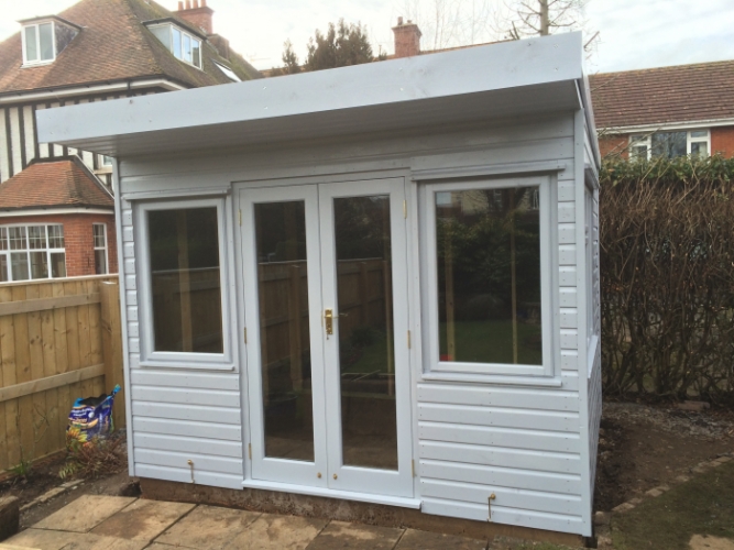 White painted shed with overhang