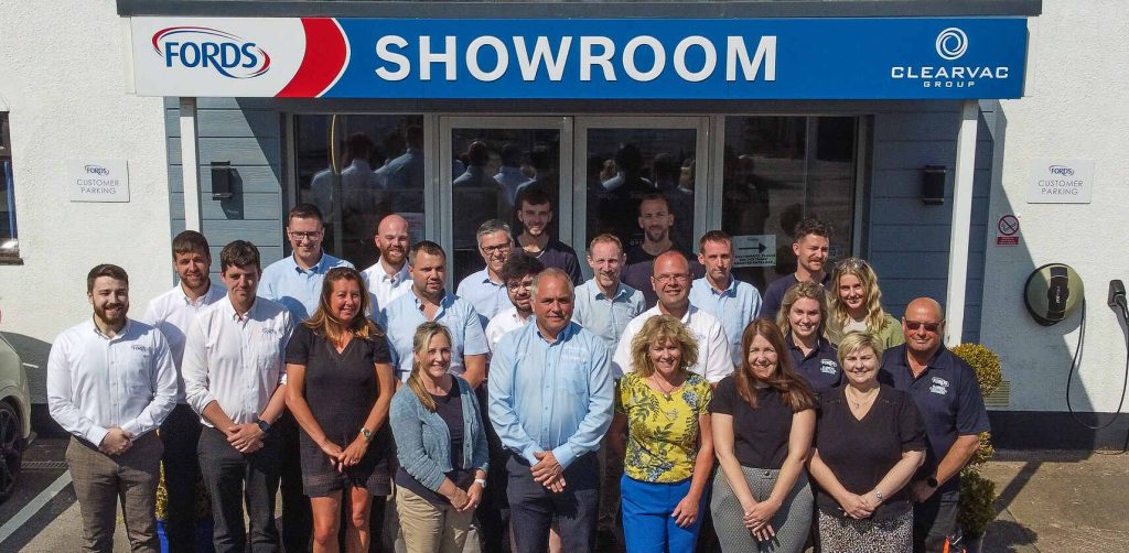 Fords team outside showroom