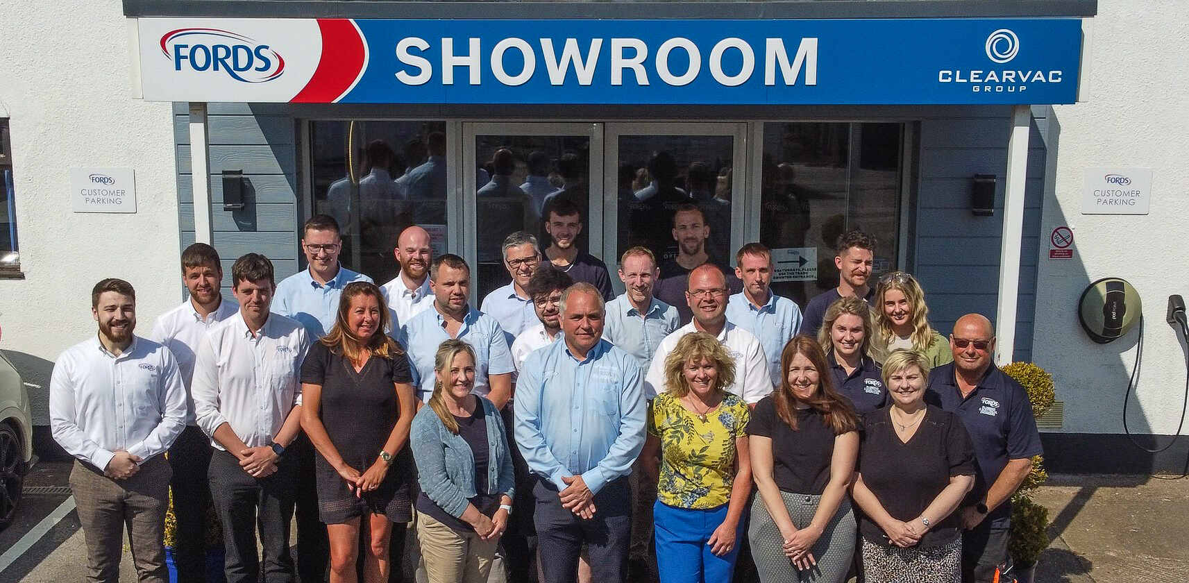 Fords team outside showroom