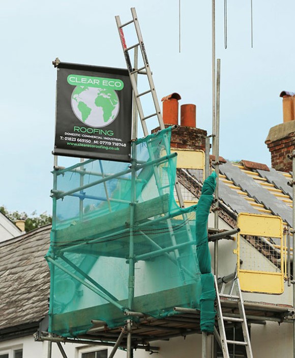 New roofing installation surrounded by scaffolding, displaying brand: 'Clear Eco Roofing'
